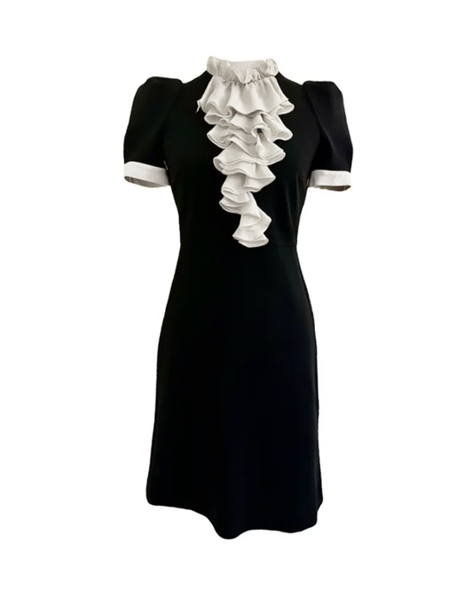 A vintage style black and white ruffle neck dress with three-quarter sleeves and a round neckline.