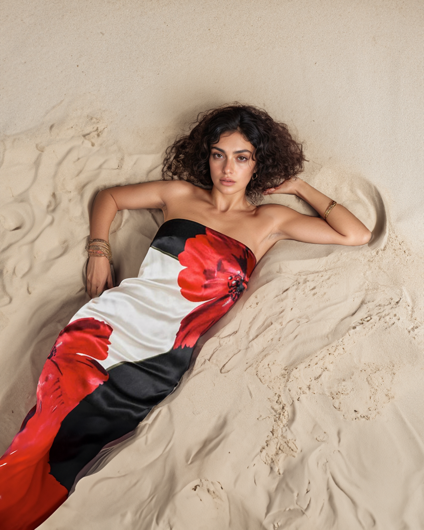 Woman lying on sand wearing a colorful dress