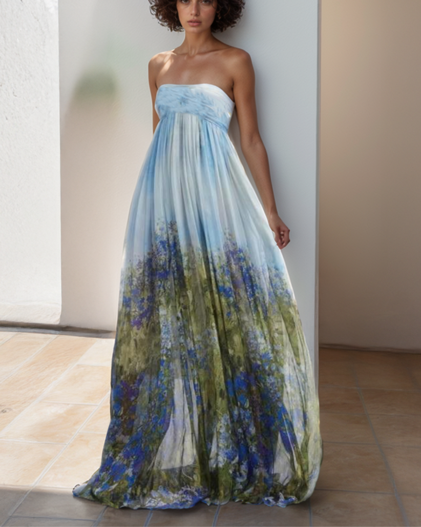 Woman wearing a strapless floral dress with a gradient of blue and green colors.