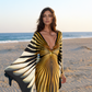 Woman in a zebra-striped dress on a beach