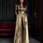 A person wearing a gold metallic vintage jumpsuit with a flattering wrap V-neck and flared pants, standing in a room with elegant decor.