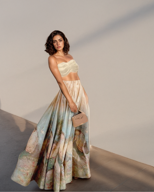 Woman wearing a strapless top and long skirt with renaissance painting print