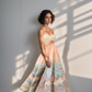 Woman wearing a strapless top and floral skirt with a renaissance print