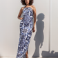 Woman wearing a blue and white patterned dress against a plain background