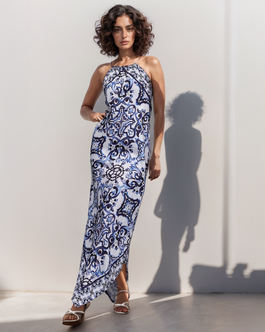 Woman wearing a blue and white patterned dress against a plain background