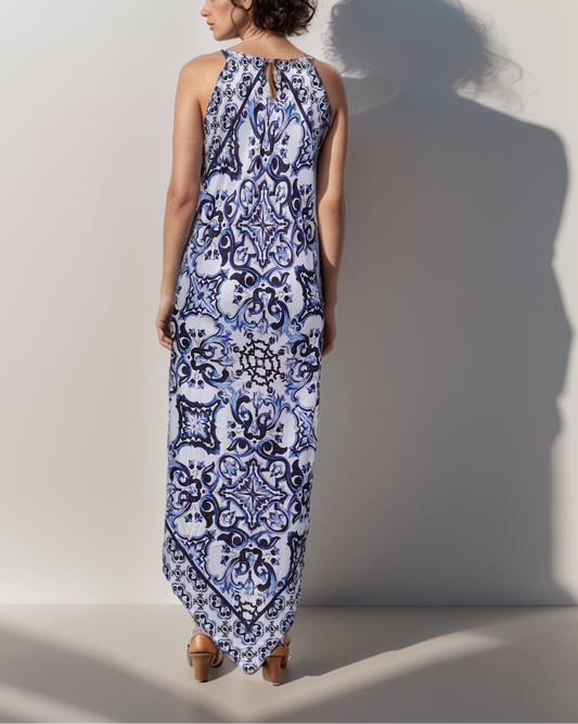 Woman wearing a blue and white patterned dress against a plain background