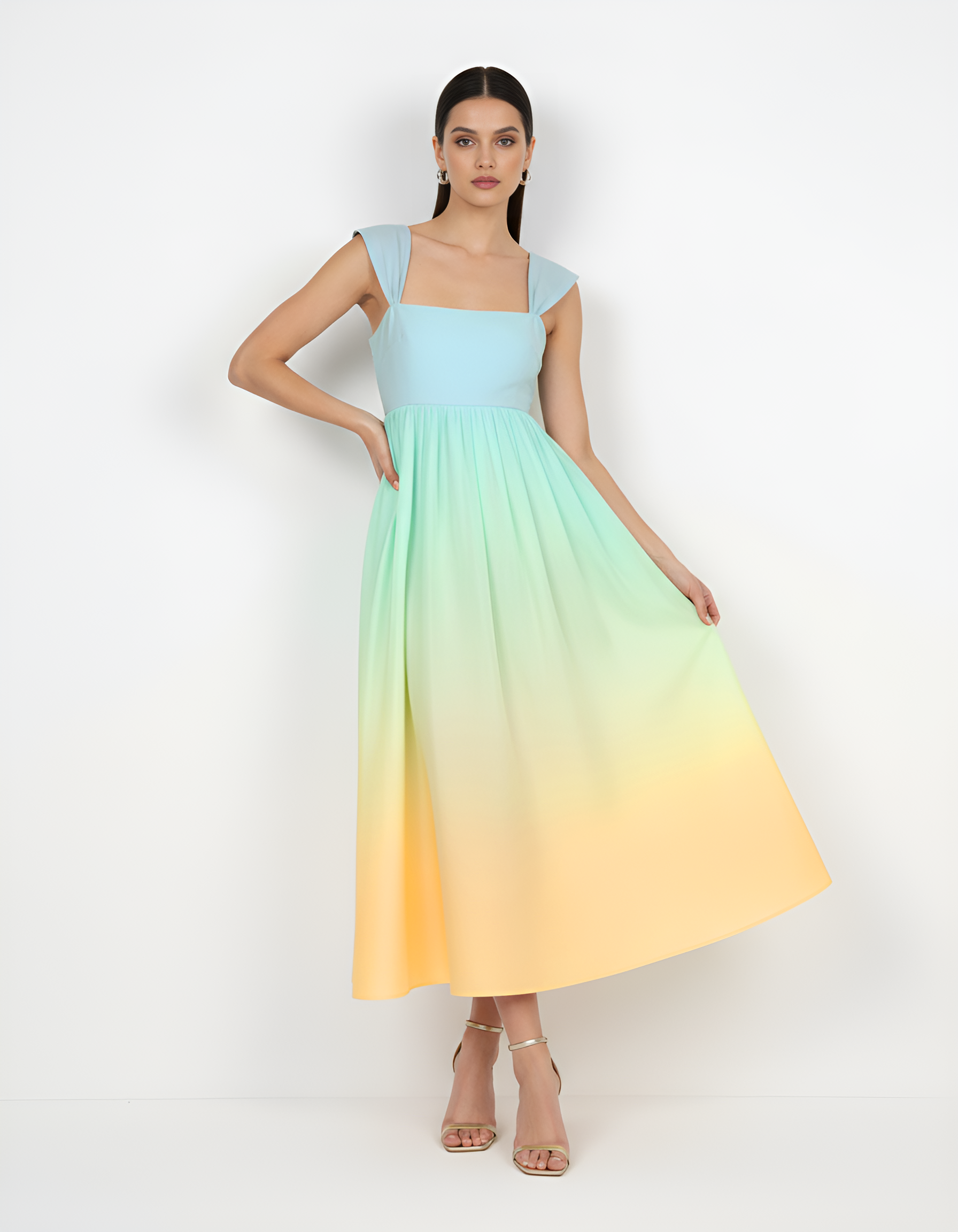 Woman wearing a gradient dress with blue, green, and yellow colors on a white background